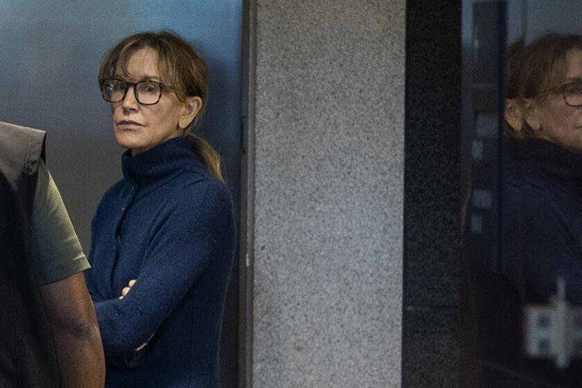 TOPSHOT - Actress Felicity Huffman is seen inside the Edward R. Roybal Federal Building and U.S. Courthouse in Los Angeles, on March 12, 2019. - Two Hollywood actresses including Oscar-nominated "Desperate Housewives" star Felicity Huffman are among 50 people indicted in a nationwide university admissions scam, court records unsealed in Boston on March 12, 2019 showed. The accused, who also include chief executives, allegedly cheated to get their children into elite schools, including Yale, Stanford, Georgetown and the University of Southern California, federal prosecutors said.Huffman, 56, and Lori Loughlin, 54, who starred in "Full House," are charged with conspiracy to commit mail fraud and honest services mail fraud. A federal judge set bond at $250,000 for Felicity Huffman after she was charged in a massive college admissions cheating scandal. (Photo by DAVID MCNEW / AFP)DAVID MCNEW/AFP/Getty Images ** OUTS - ELSENT, FPG, CM - OUTS * NM, PH, VA if sourced by CT, LA or MoD **