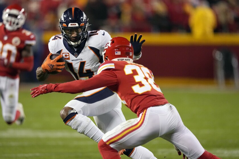 Denver Broncos wide receiver Courtland Sutton (14) runs with the ball as Kansas City Chiefs cornerback L'Jarius Sneed (38) defends during the second half of an NFL football game Sunday, Dec. 5, 2021, in Kansas City, Mo. (AP Photo/Charlie Riedel)