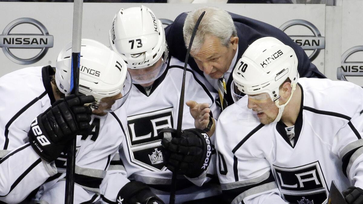 Kings Coach Darryl Sutter, top right, speaks with players Anze Kopitar, left, Tyler Toffoli, center, and Tanner Pearson during a game against the Nashville Predators on Nov. 25.
