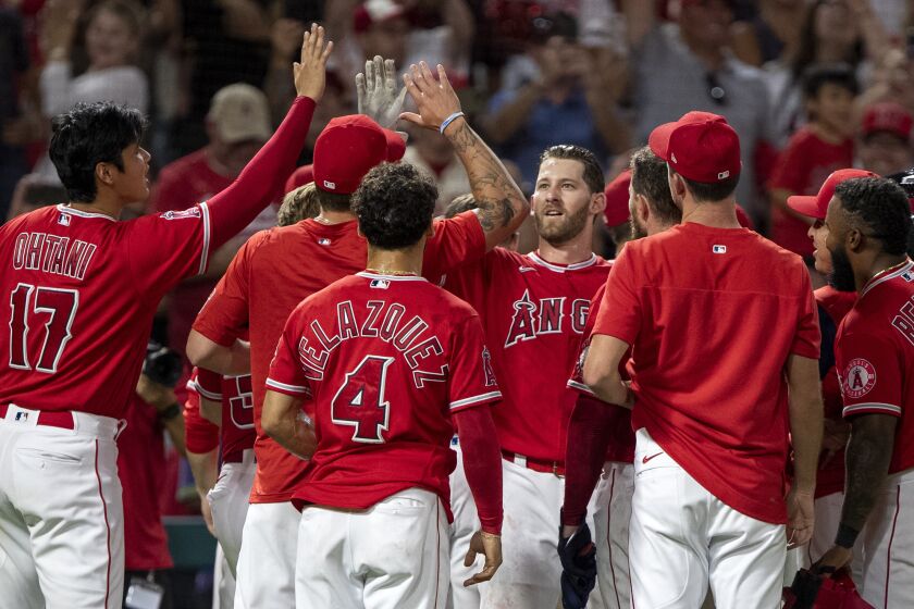 Los Angeles Angels' Taylor Ward, center, celebrates with teammates after his two-run home run.