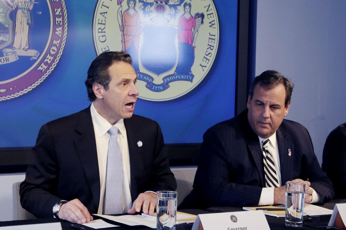 New York Gov. Andrew Cuomo, left, and New Jersey Gov. Chris Christie at a news conference Friday to announce a quarantine.