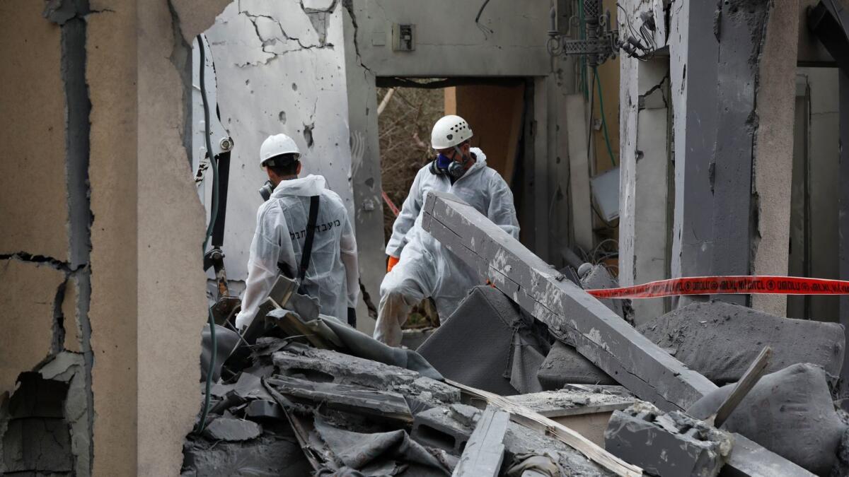 In Mishmeret, north of Tel Aviv, Israeli police examine a house struck by a missile reportedly fired by militants from the Gaza Strip on March 25, 2019.