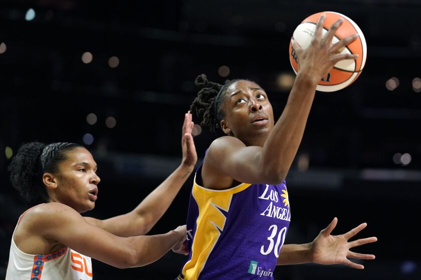 Los Angeles Sparks forward Nneka Ogwumike, right, tries to shoot as Connecticut Sun forward Alyssa Thomas defends during the first half of a WNBA basketball game Thursday, Aug. 11, 2022, in Los Angeles. (AP Photo/Mark J. Terrill)