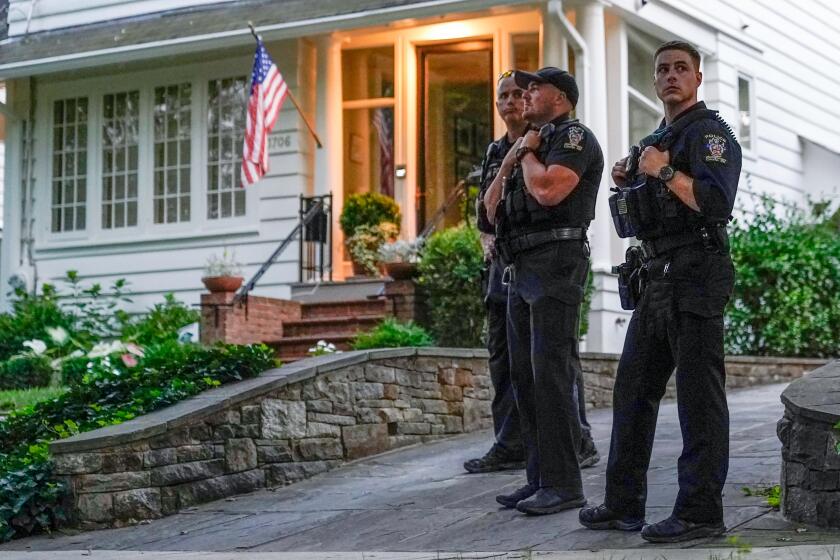 Members of the Montgomery County Police Department stand outside the home of Supreme Court Justice Brett Kavanaugh