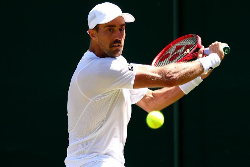 LONDON, ENGLAND - JULY 04: Steve Johnson of The United States plays a backhand in his Men's Singles second round match against Alex de Minaur of Australia during Day four of The Championships - Wimbledon 2019 at All England Lawn Tennis and Croquet Club on July 04, 2019 in London, England. (Photo by Clive Brunskill/Getty Images) ** OUTS - ELSENT, FPG, CM - OUTS * NM, PH, VA if sourced by CT, LA or MoD **