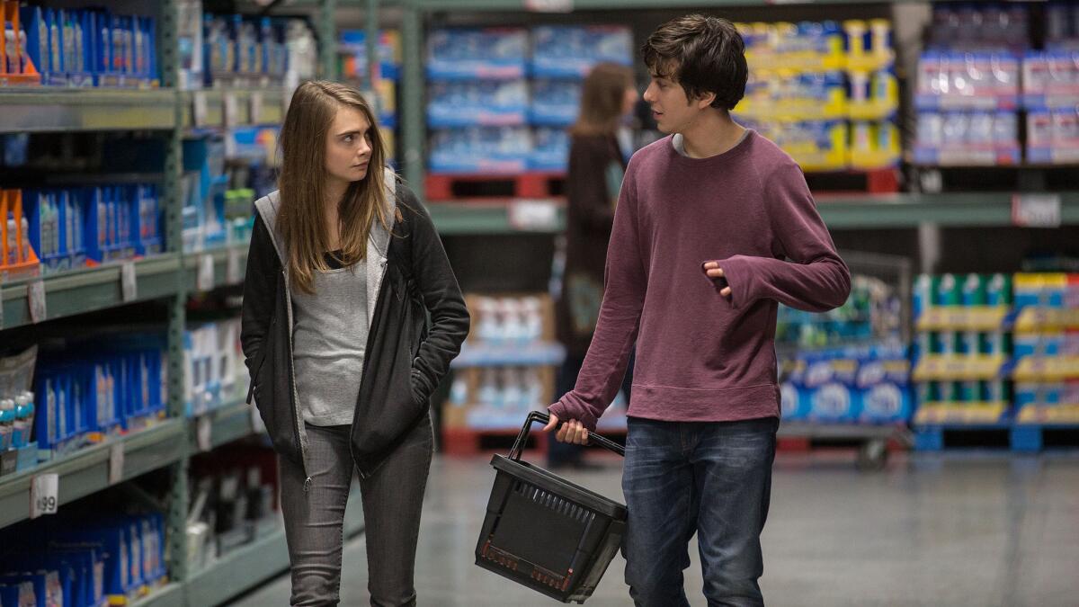 Cara Delevingne, left, as Margo, and Nat Wolff as Quentin, in a scene from the new film, "Paper Towns."