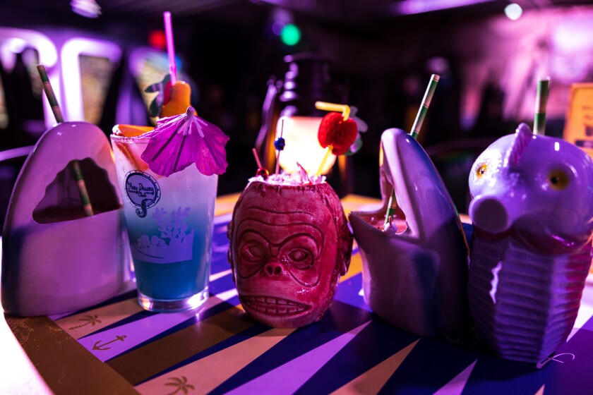 Tiki cocktails served in festive glasses at the Acey-Deucey Club.