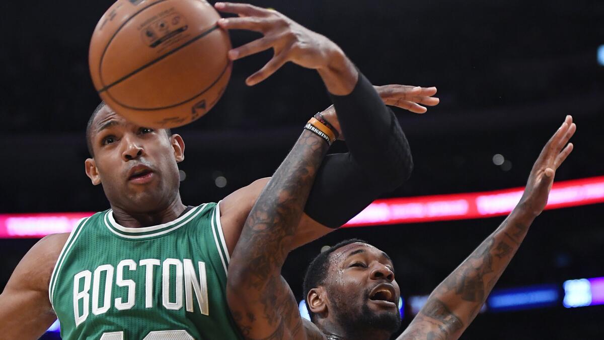 Celtics center Al Horford and Lakers center Tarik Black battle for a rebound during the first half Friday.