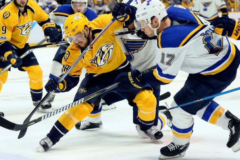 Nashville Predators left wing Viktor Arvidsson, center left, competes for the puck against St. Louis Blues left wing Jaden Schwartz (17) in the first period of Game 3 of an NHL hockey playoff series, Sunday, April 30, 2017, at the Bridgestone Arena in Nashville, Tenn. (Chris Lee/St. Louis Post-Dispatch via AP)