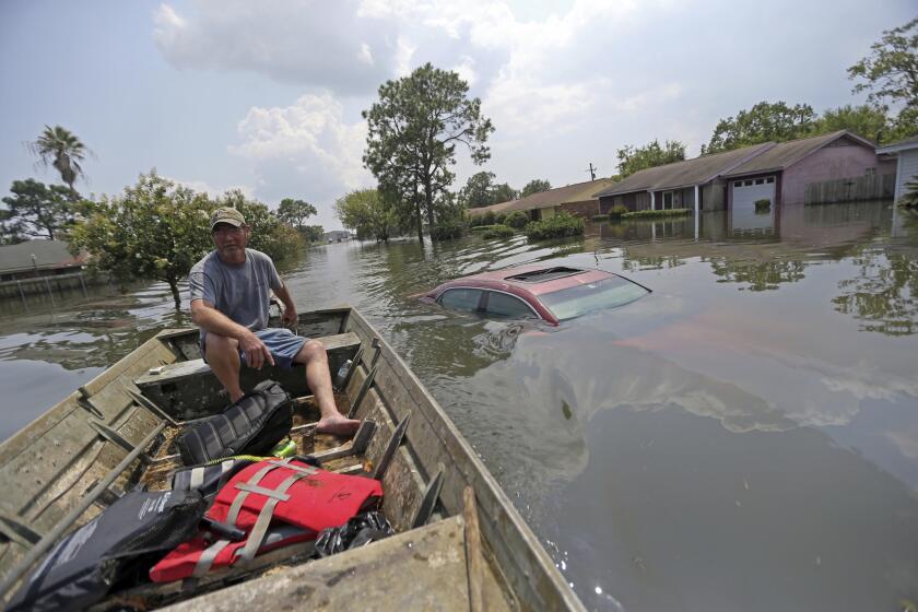 Paul England pilots his boat through floodwaters in the aftermath of Tropical Storm Harvey in Port Arthur, Texas, on Sept. 2, 2017.