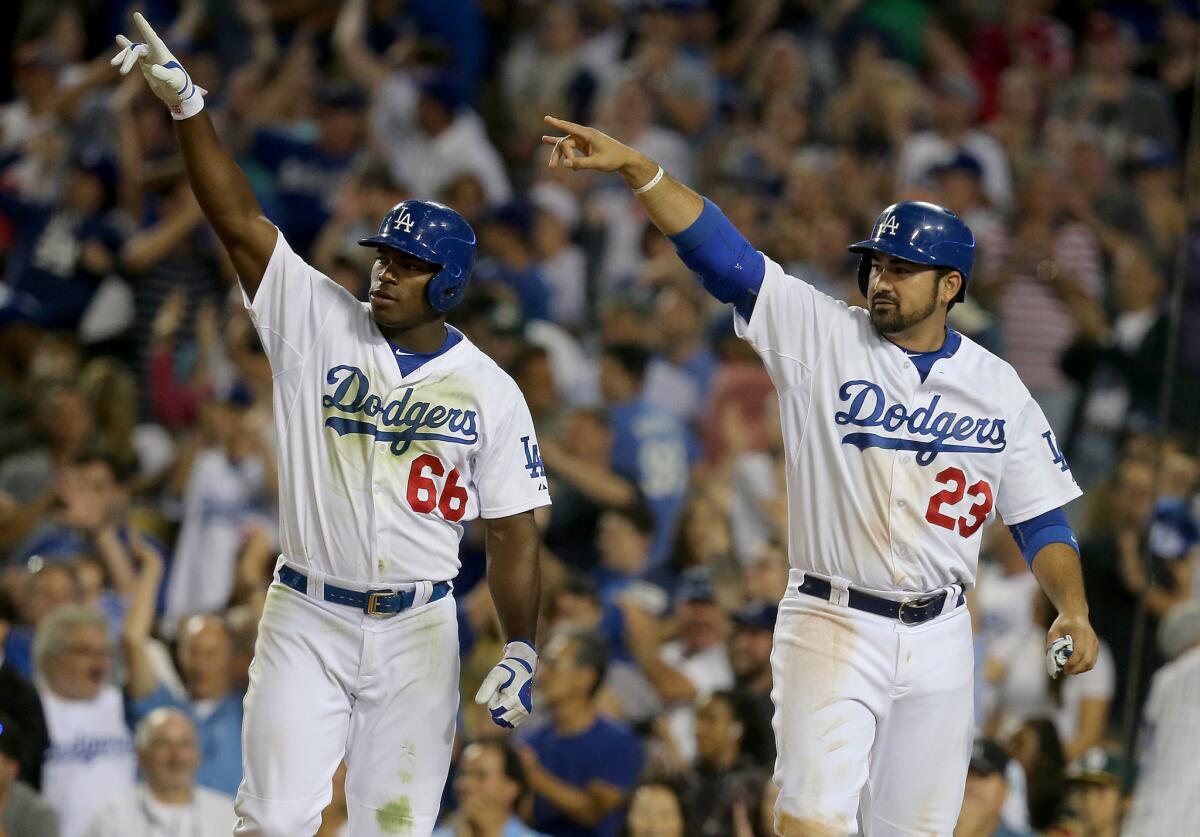 Yasiel Puig (66) and Adtian Gonzalez (23) gesture to pinch hitter Enrique Hernandez, whose two-run double gave the Dodgers a late lead against the Oakland Athletics.