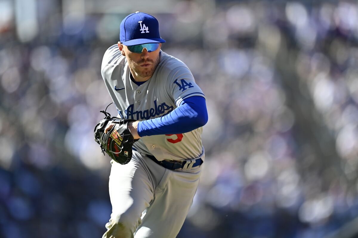 Freddie Freeman fields a ball Friday during the game between the Dodgers and the Rockies in Denver.
