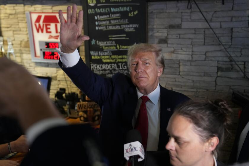 Former President Donald Trump greets supporters at the Treehouse Pub & Eatery, Wednesday, Sept. 20, 2023, in Bettendorf, Iowa. (AP Photo/Charlie Neibergall)