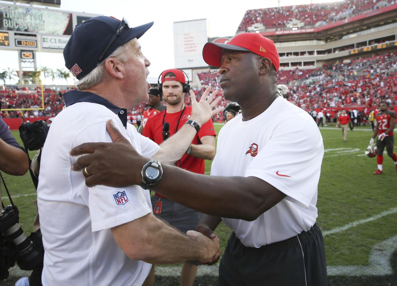 Bears coach John Fox, left, with Buccaneers coach Lovie Smith at the end of their teams' game at Raymond James Field in Tampa, Fla. The Bears won 26-21 on Dec. 27, 2015.