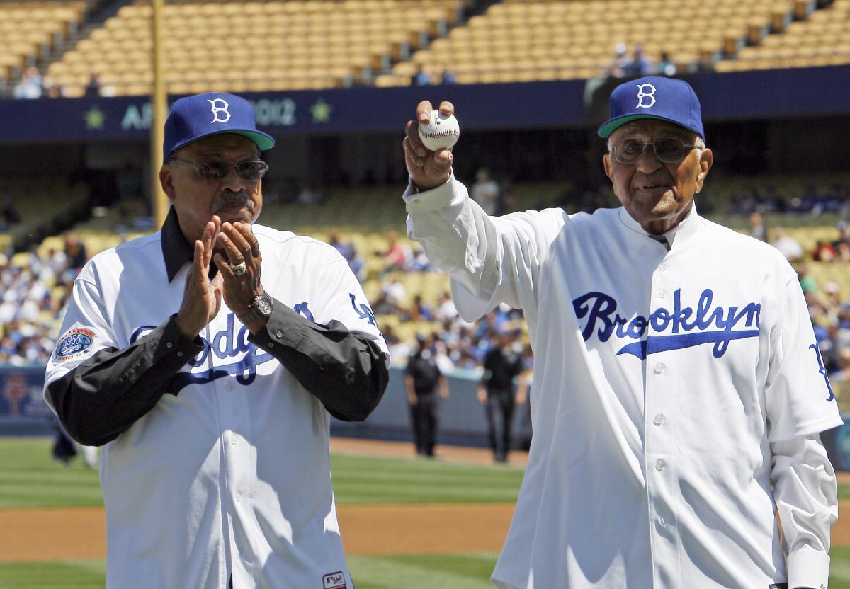 Dodger greats Tommy Davis, left, and Don Newcombe are honored before a game.