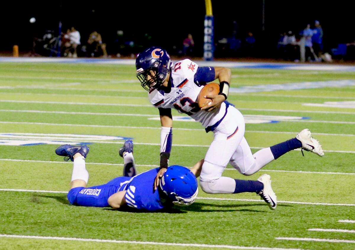 Chaminade quarterback Jayden Henderson is tripped up by Norco linebacker Brandon Manley.