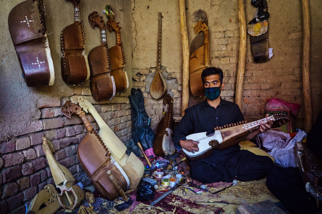 Izzatullah Neamat tunes a rubab 