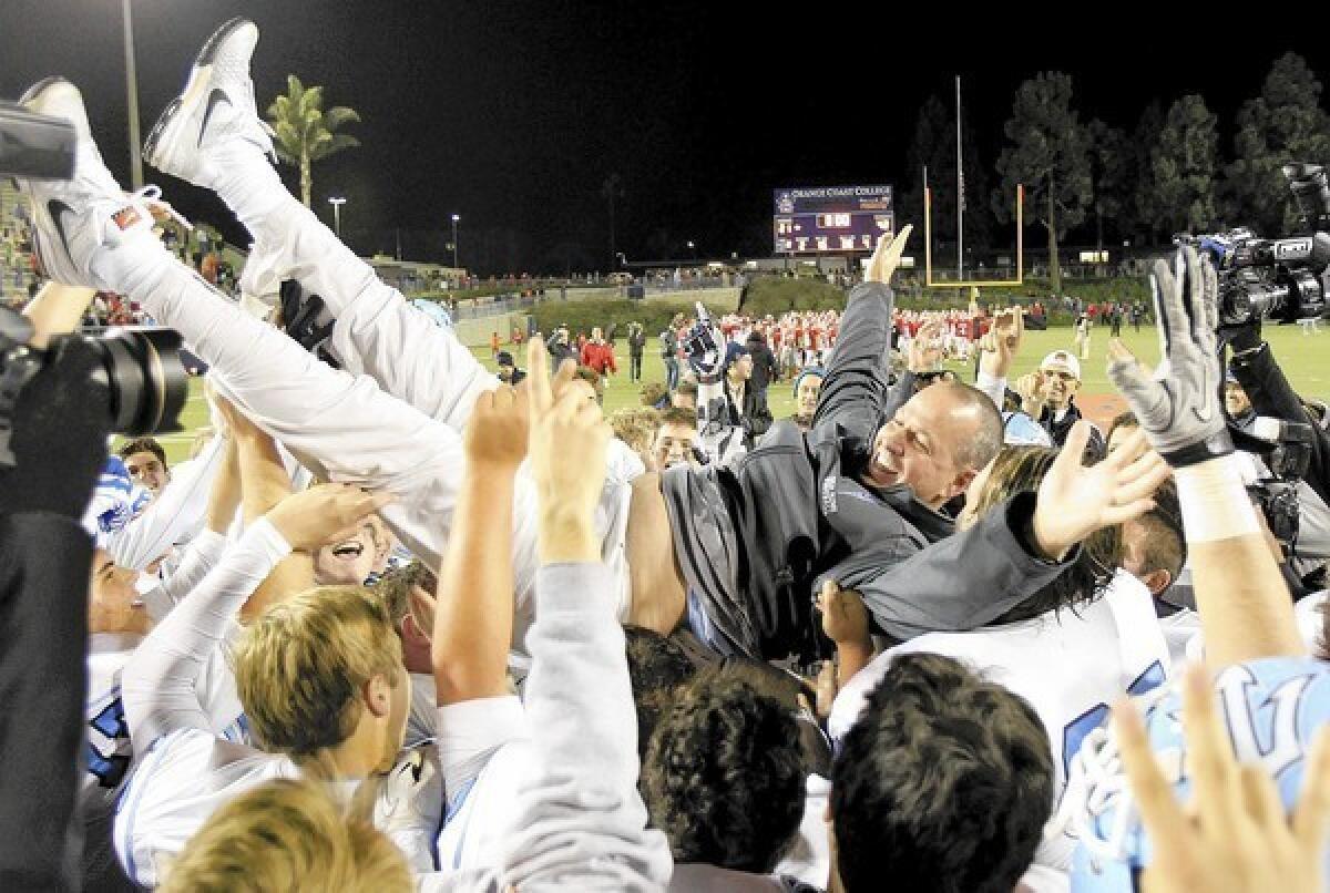 Corona del Mar High head coach Scott Meyer is held up by his players after the Sea Kings defeated Garden Grove, 42-21, in a CIF Southern Section Southern Division championship game at LeBard Stadium in Costa Mesa on Friday.