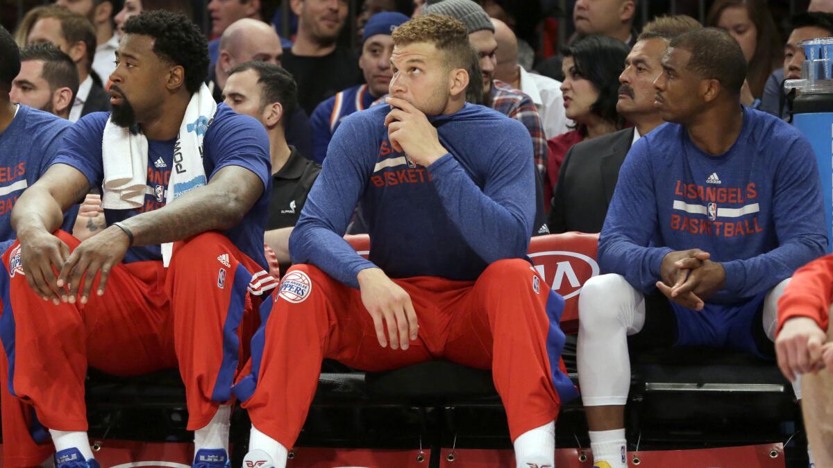 Clippers teammates (from left) DeAndre Jordan, Blake Griffin and Chris Paul sit on the bench during a win over the New York Knicks on March 25, 2015.
