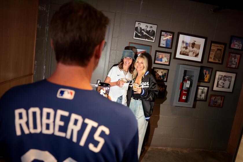 Dodger fans enjoy themselves at the Speakeasy under the right field pavilion at Dodgers Stadium. 