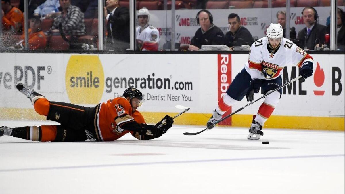 Ducks left wing Joseph Cramarossa dives for the puck as Panthers center Vincent Trocheck takes it during the third period of a game on Feb. 17.