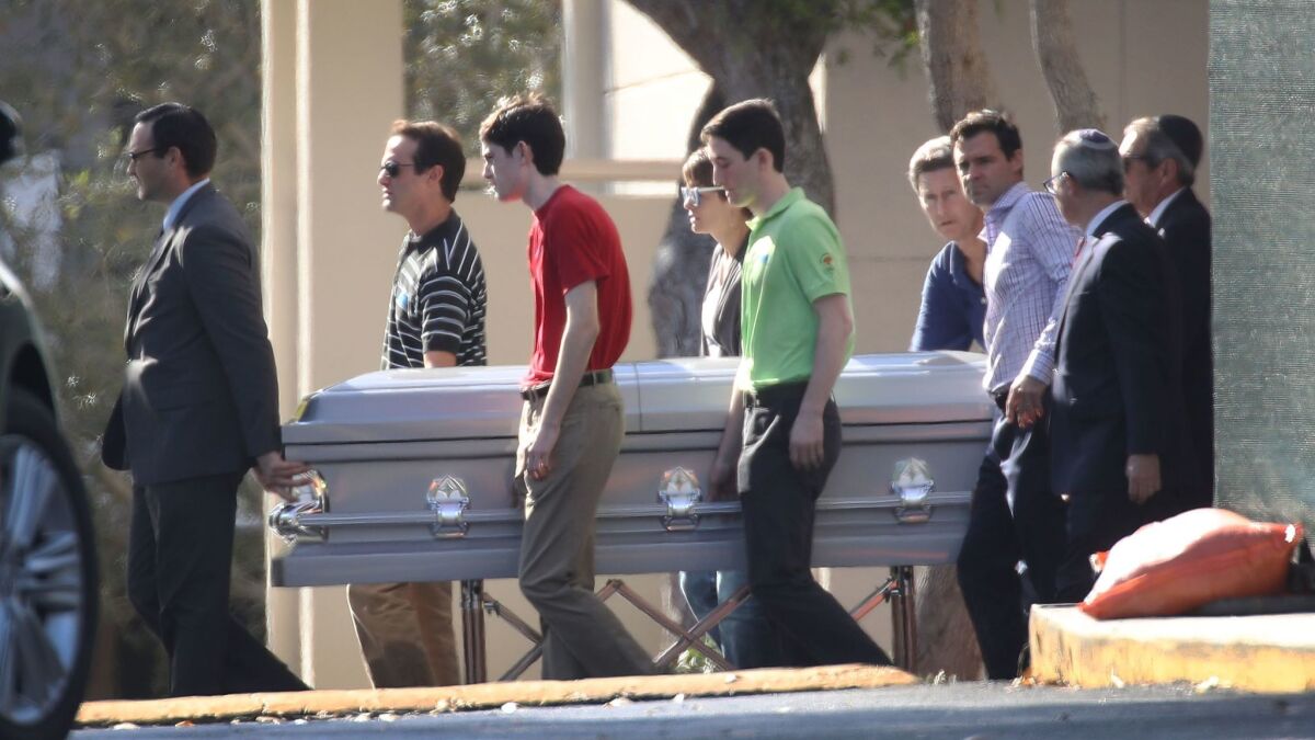 Pallbearers carry the casket of Scott Beigel, a geography teacher at Marjory Stoneman Douglas High School, after a funeral service at Temple Beth-El on Feb. 18, 2018, in Boca Raton, Fla.