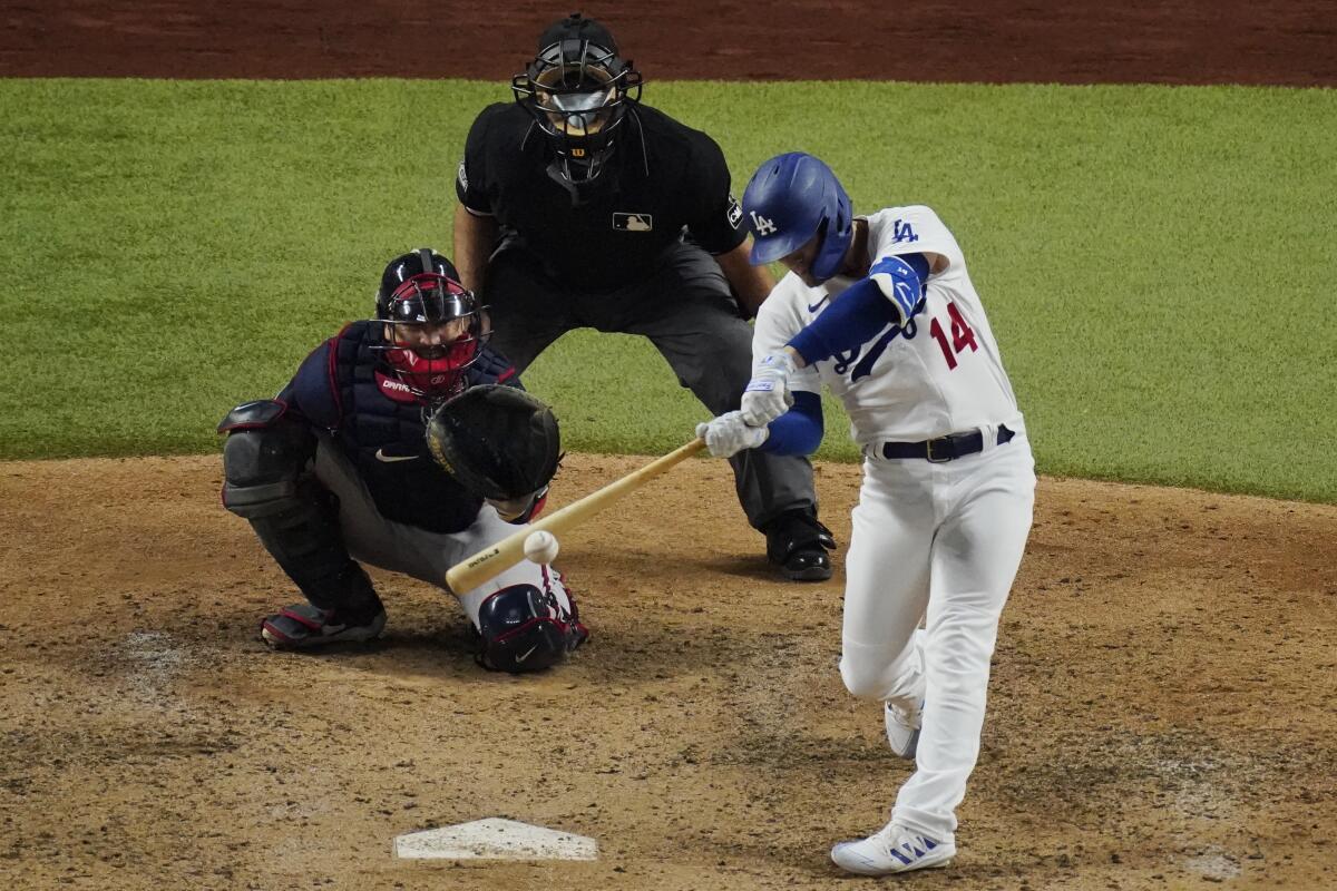 Dodgers second baseman Kiké Hernández hits a home run against the Atlanta Braves.