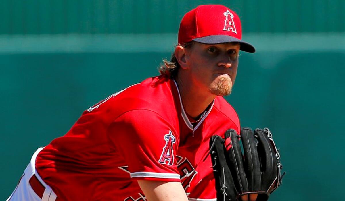 Angels starting pitcher Jered Weaver warms up between innings during a spring training game against the Dodgers.