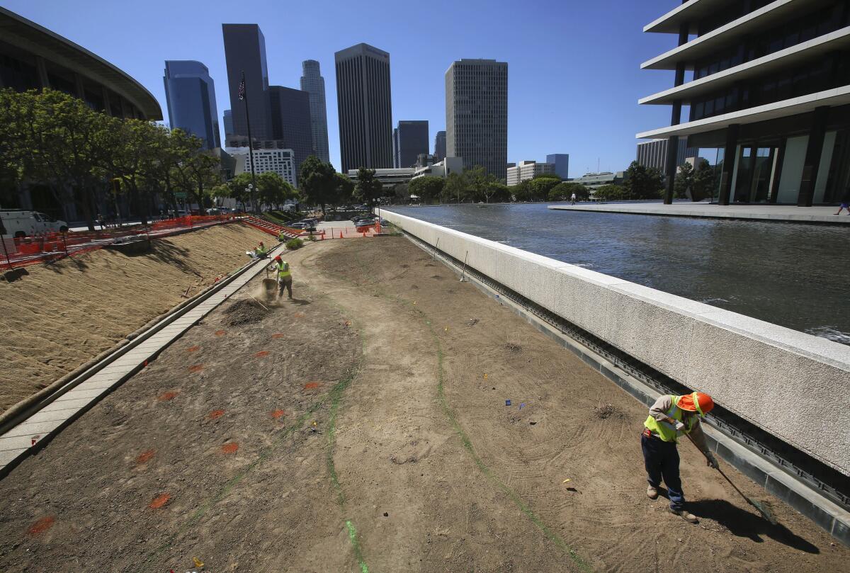 L.A. Department of Water and Power employees prepare ground for a drought resistant garden outside DWP headquarters in downtown Los Angeles. With data in for the most recent rainy season, downtown has seen its lowest four-year rainfall total since record-keeping began in 1877.