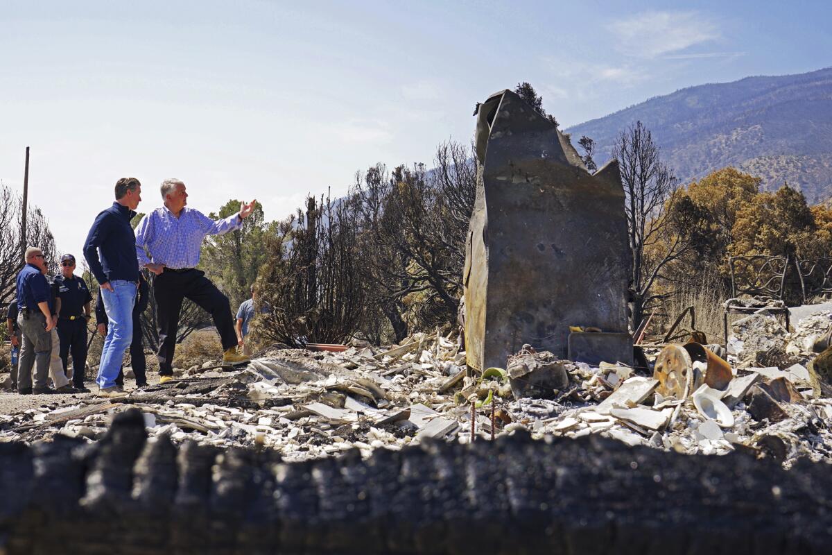 People stand on rubble and debris 