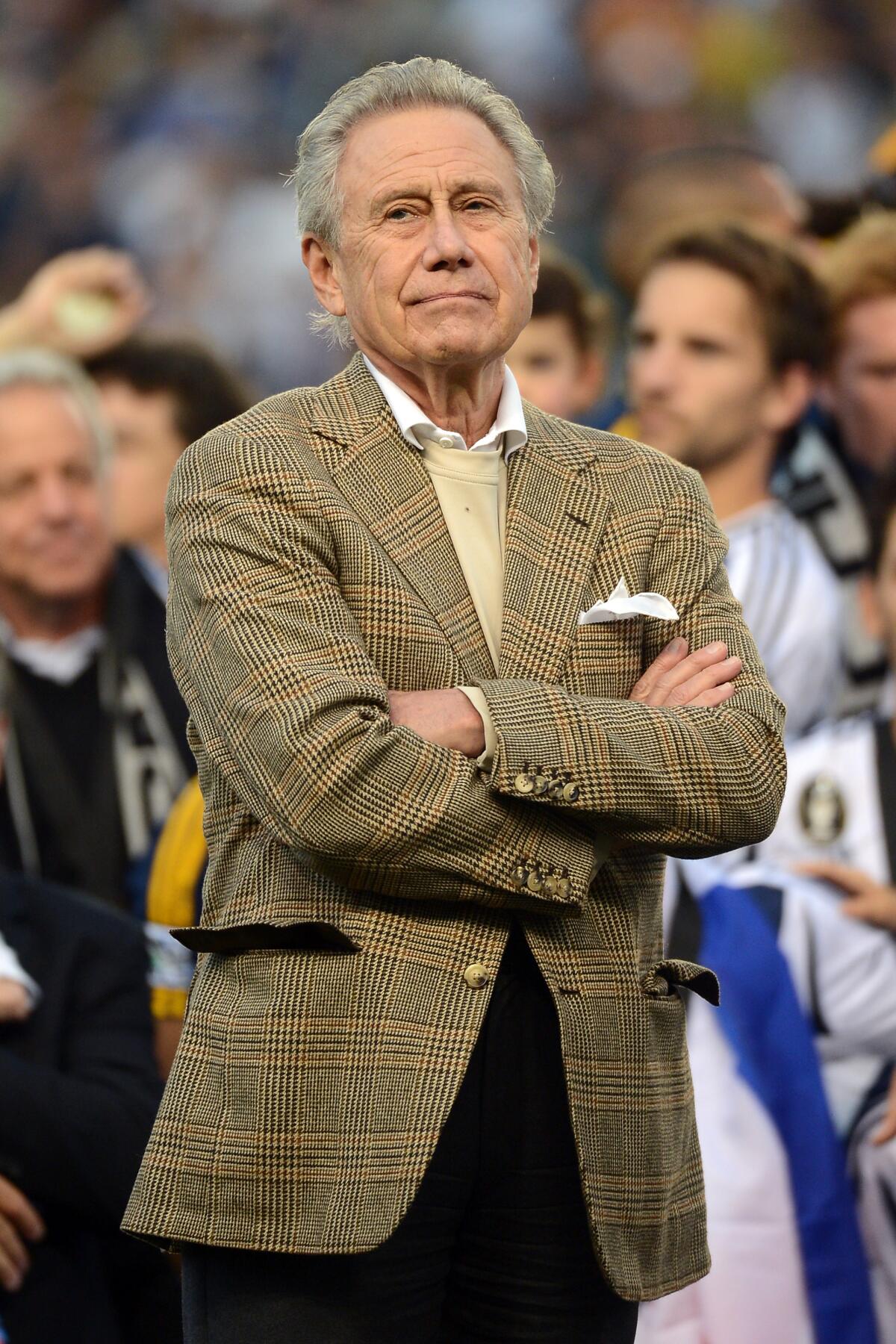 Phil Anschutz stands with his arms crossed