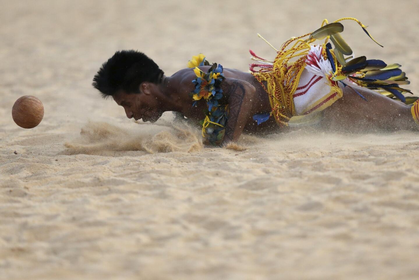 An indigenous man from the Paresi tribe tries to head the ball during the Jikunahati competition, a form of soccer played with one's head, at the first World Games for Indigenous Peoples in Palmas
