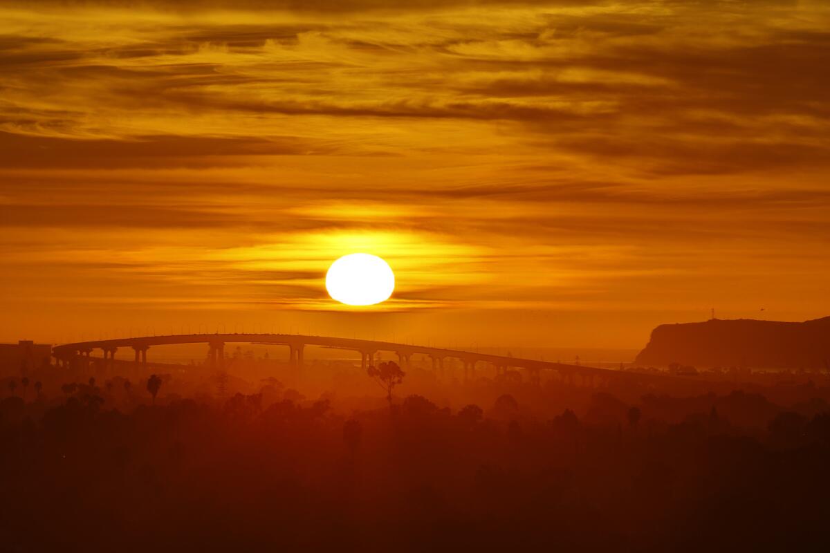 The suns sets with the iconic span of the San Diego–Coronado Bridge in the foreground in this file photo.