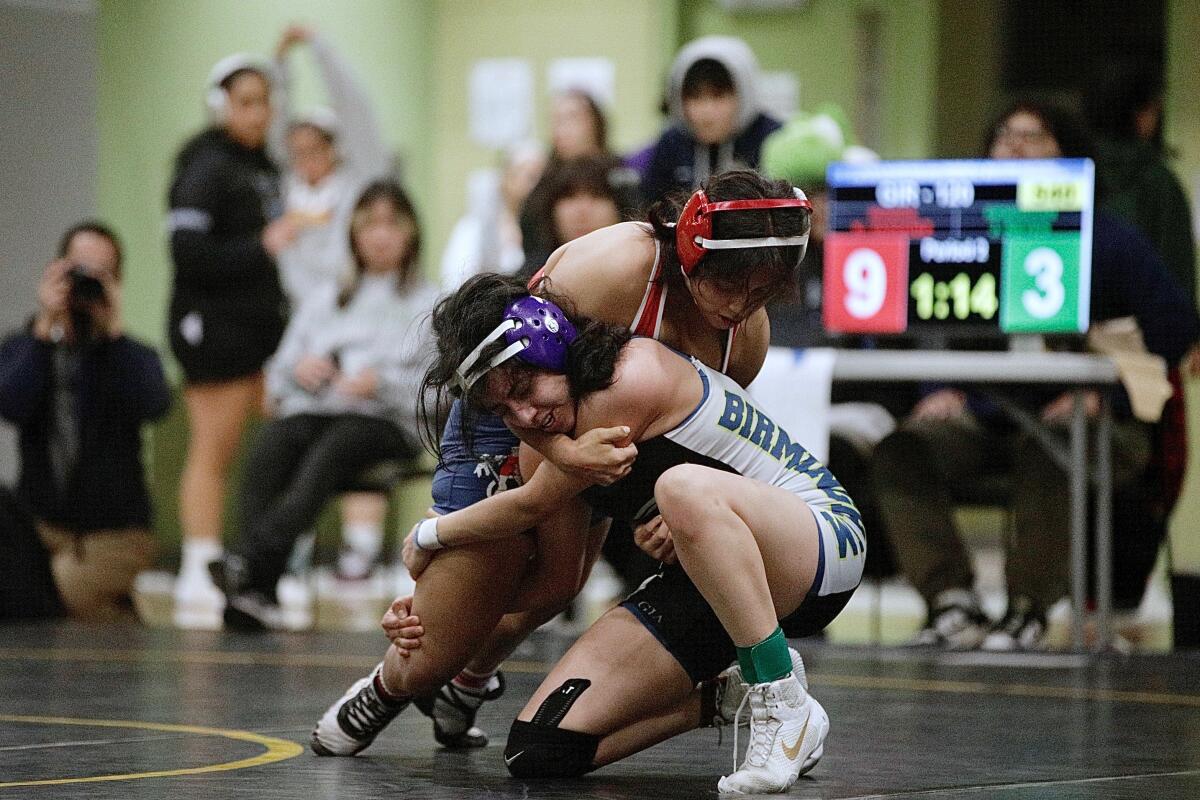 Monroe’s Kayla Vasquez (top) tries to pin Birmingham’s Jimena Reyes in the girls’ 120-pound City Section final.