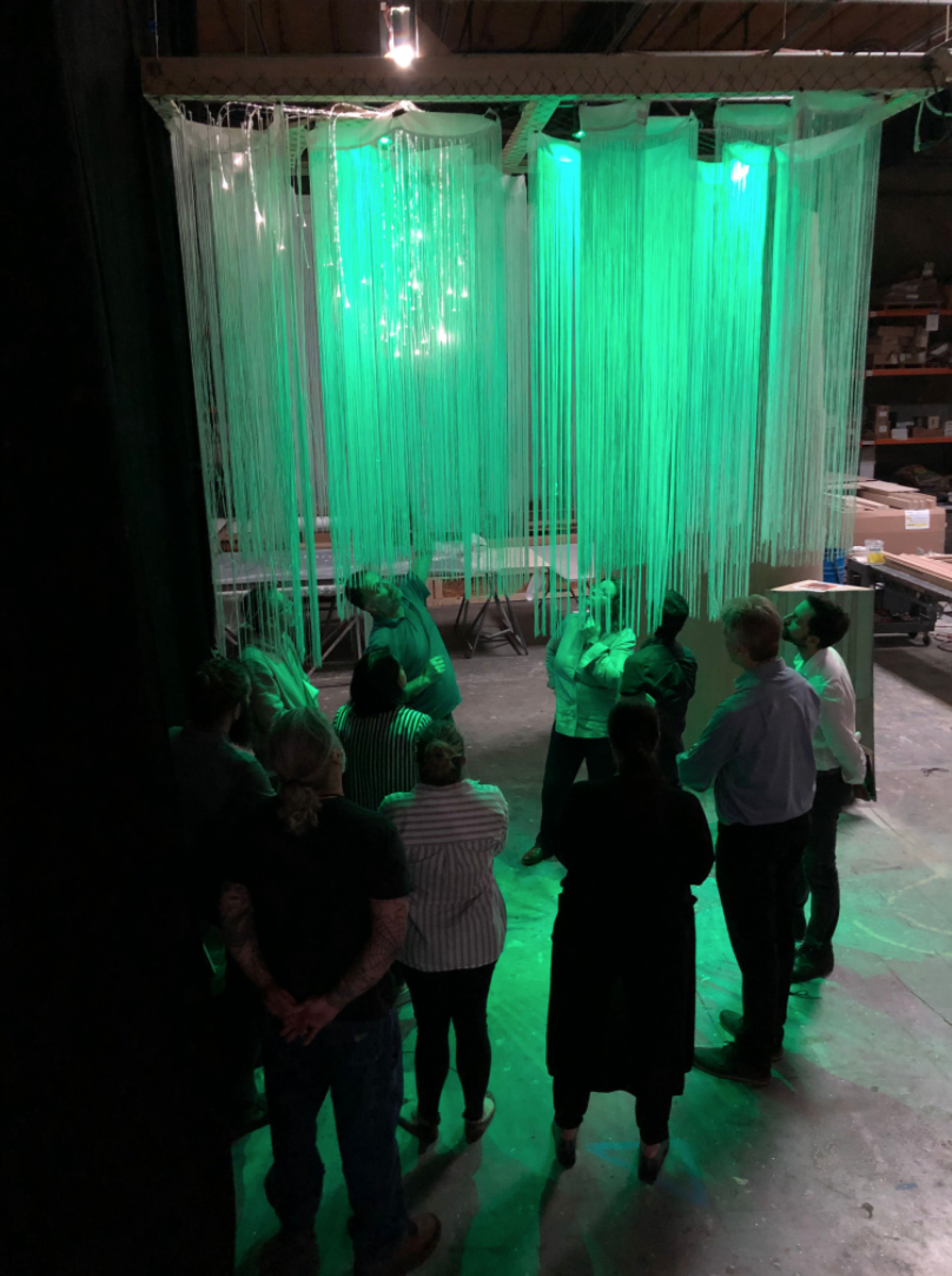 Museum staffers look at a mock-up of the Mother Tree to test materials, lighting and construction process in March 2020.