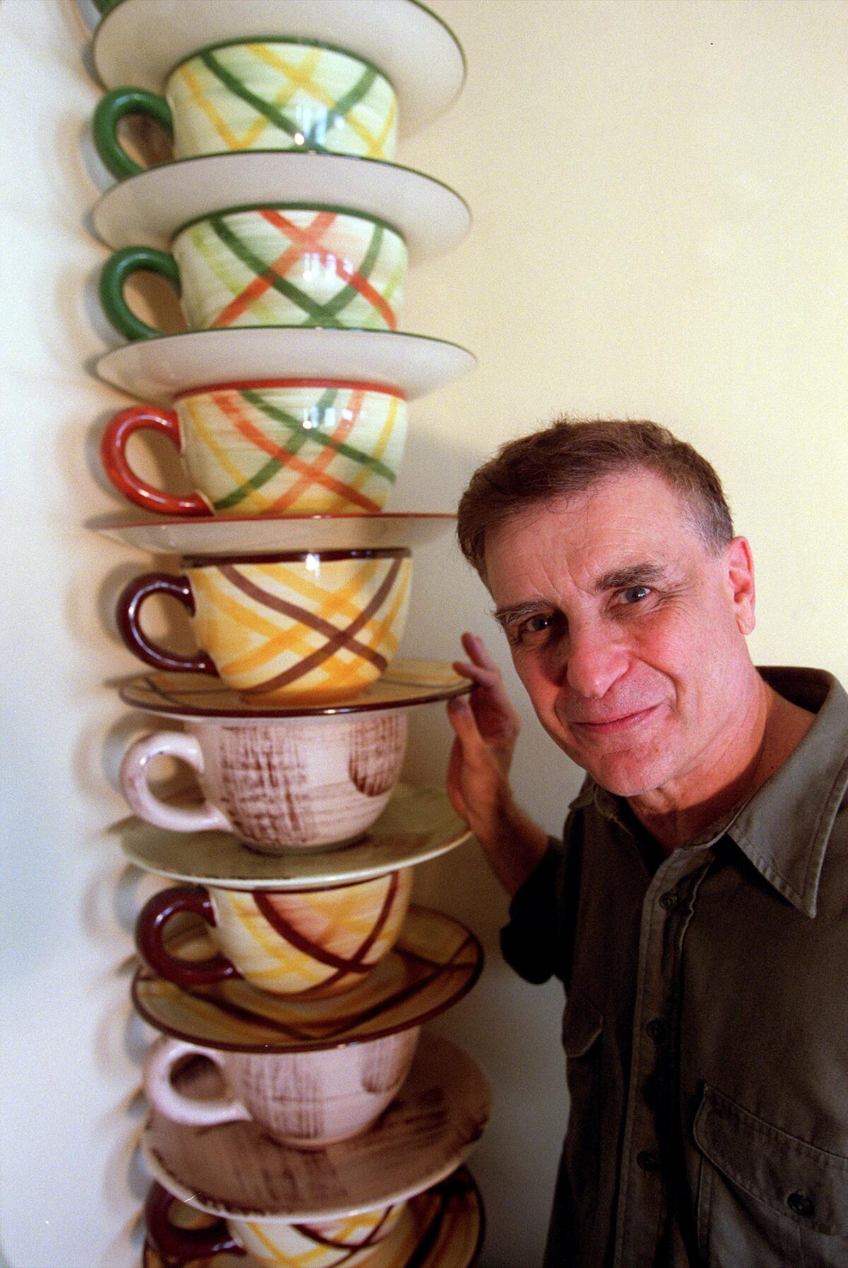 In 2001, Bill Stern posed with quirky pieces from his ceramics collection — a stack of oversized coffee cups.