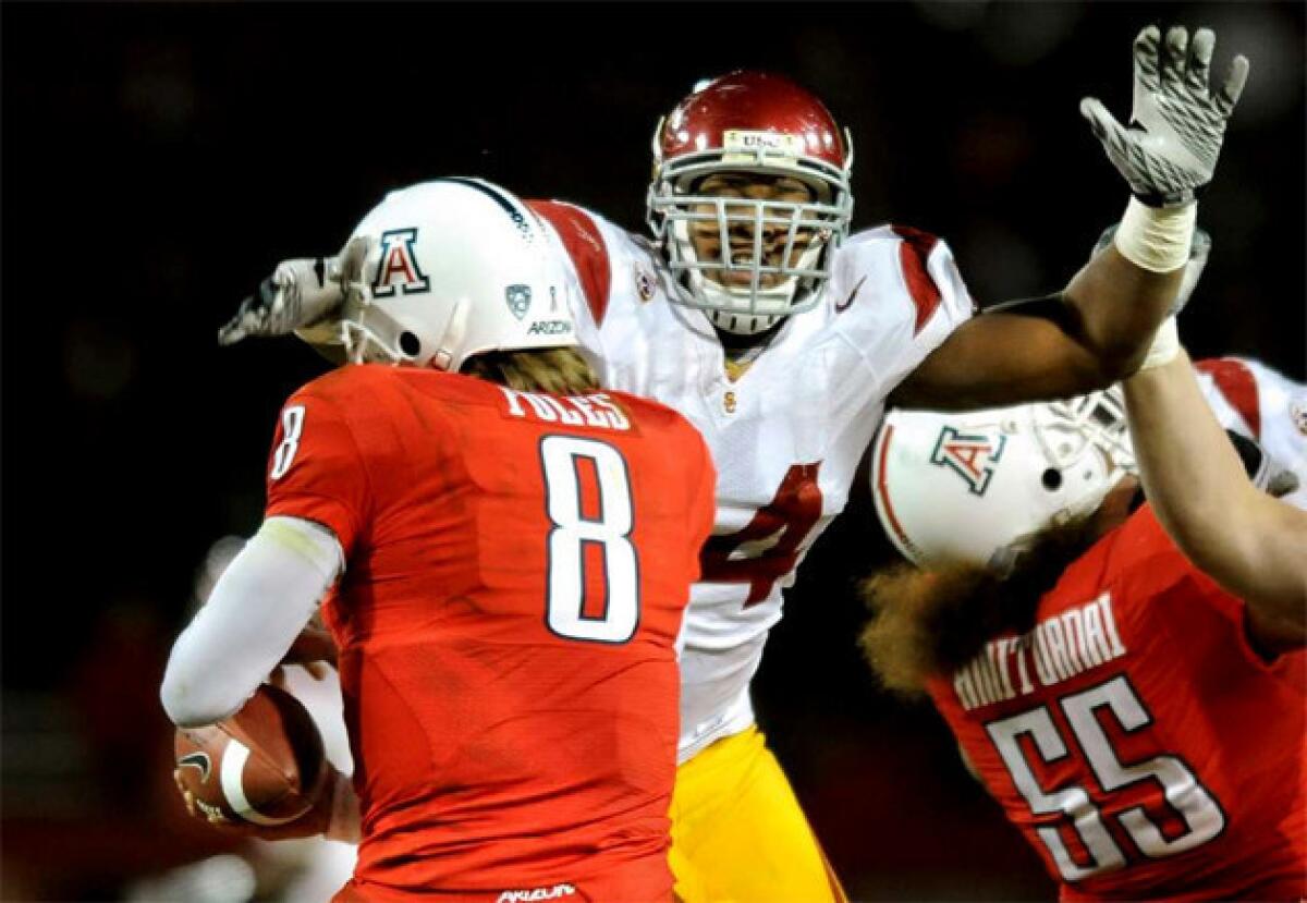 Armond Armstead gets a hand to the face of Arizona quarterback Nick Foles in 2010.
