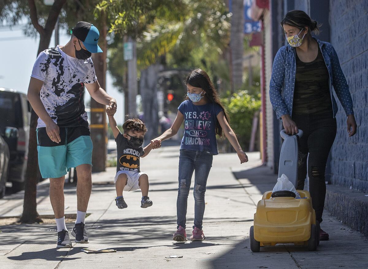 A family goes for a walk in Boyle Heights