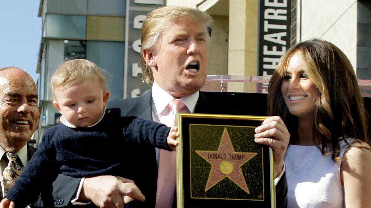 Donald Trump, with his wife, Melania, and their son, Barron, pose for a photo after he was given a star on the Hollywood Walk of Fame.