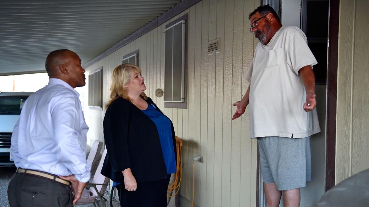 Lesia Romanov meets William Seddon, right, at his Pahrump, Nev., mobile home as she canvasses for state Assembly.