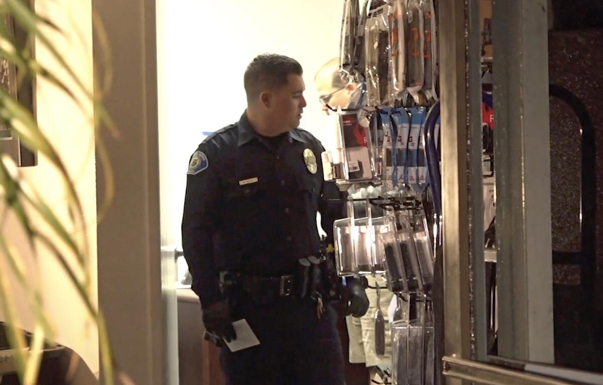 Police officer investigates a robbery in a store.