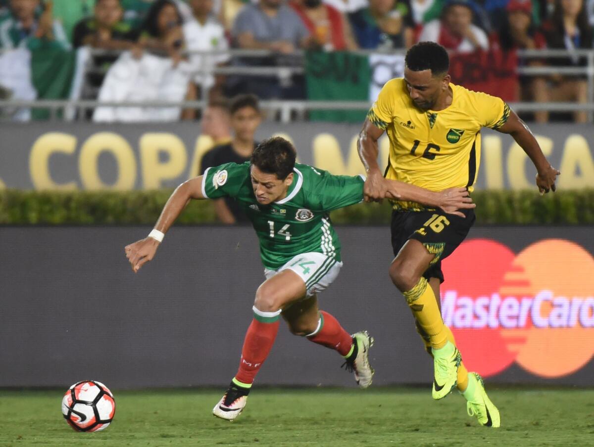 Mexico's Javier 'Chicharito' Hernandez (L) is marked by Jamaica's Lee Williamson during the Copa America Centenario football tournament in Pasadena, California, United States, on June 9, 2016. / AFP PHOTO / Mark RalstonMARK RALSTON/AFP/Getty Images ** OUTS - ELSENT, FPG, CM - OUTS * NM, PH, VA if sourced by CT, LA or MoD **