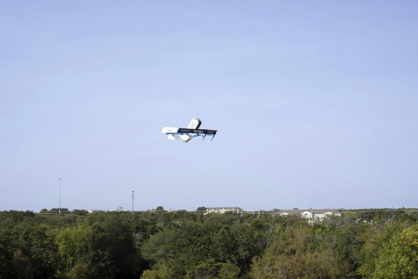 This photo provided by Amazon shows a drone delivering presciption drugs in College Station, Texas. Amazon will soon make prescription drugs fall from the sky when the e-commerce giant becomes the latest company to test drone deliveries for medications. The company said Wednesday, Oct. 18, 2023 that customers in College Station, Texas, can now get prescriptions delivered by a drone within an hour of placing their order. (Amazon via AP)