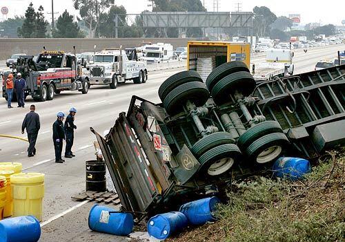 The southbound San Diego Freeway (405) was shutdown for hours after a truck overturned spilling 55-gallon drums of acetone and rubbing alcohol.