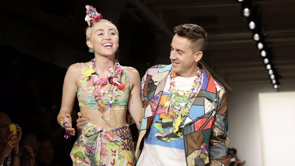 Miley Cyrus and Jeremy Scott at the designer's fashion show in September 2014.