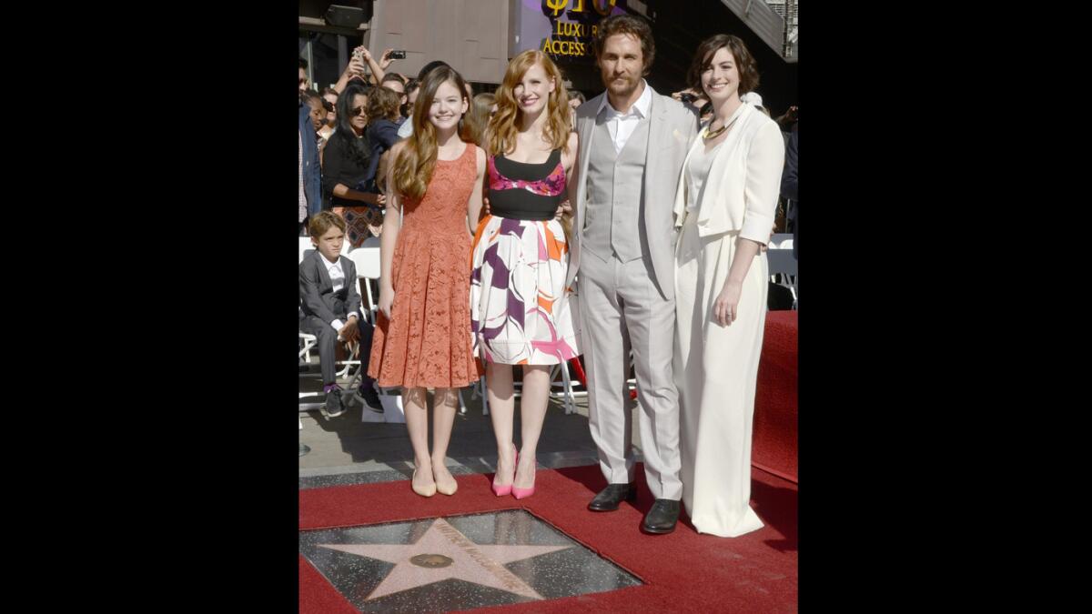 Actor Matthew McConaughey poses with Mackenzie Foy, left, Jessica Chastain and Anne Hathaway during a ceremony honoring him with a star on the Hollywood Walk of Fame.