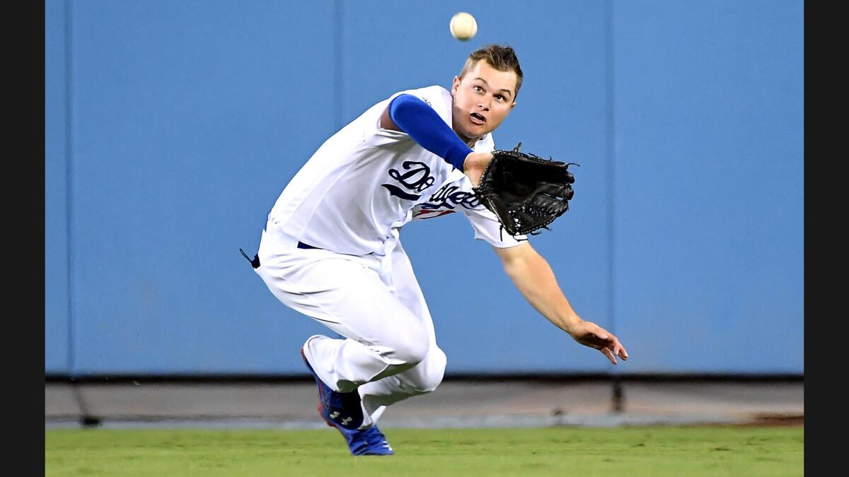 Dodgers center fielder Joc Pederson makes a catch on a fly ball by Cubs' Javier Baez in the sixth inning in Game 4 of the NLCS at Dodger Stadium on Oct. 19.