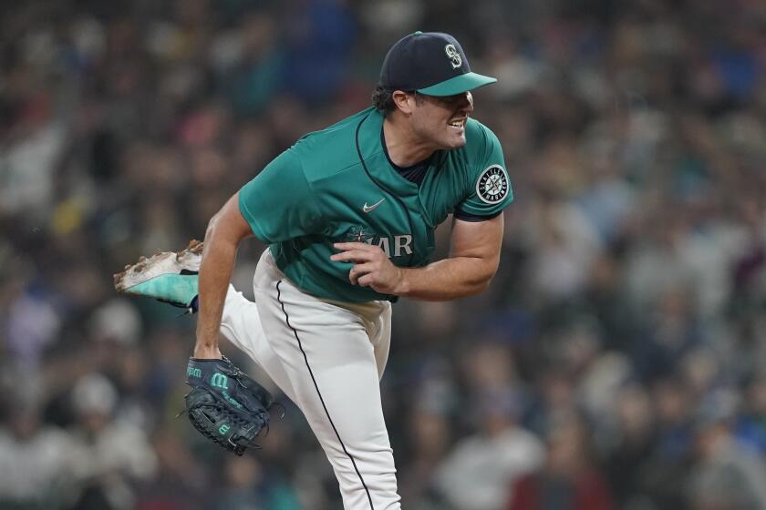 Seattle Mariners starting pitcher Robbie Ray follows through after giving up a single to catcher Max Stassi.