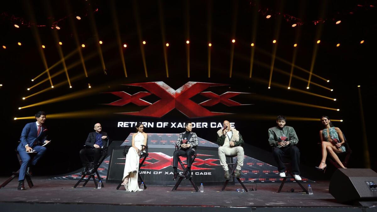 The cast of "xXx: Return of Xander Cage" discusses the movie with a moderator at a news conference in Beijing.