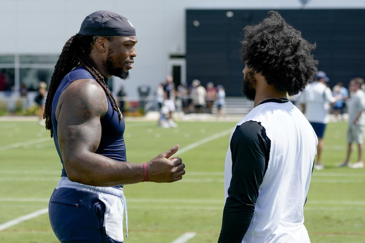 Tennessee Titans running back Derrick Henry, left, talks with Arizona Cardinals quarterback Kyler Murray after a combined practice during NFL football training camp Wednesday, Aug. 24, 2022, in Nashville, Tenn. (AP Photo/Mark Humphrey)